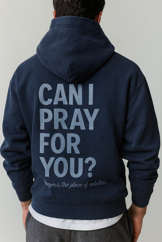Navy blue hoodie with text on the back worn by a person, on a plain background